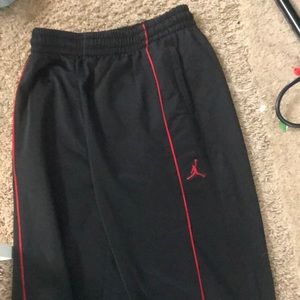 Rero Jordan sweet pants red and black with Jordan logo and zipper at the bottom